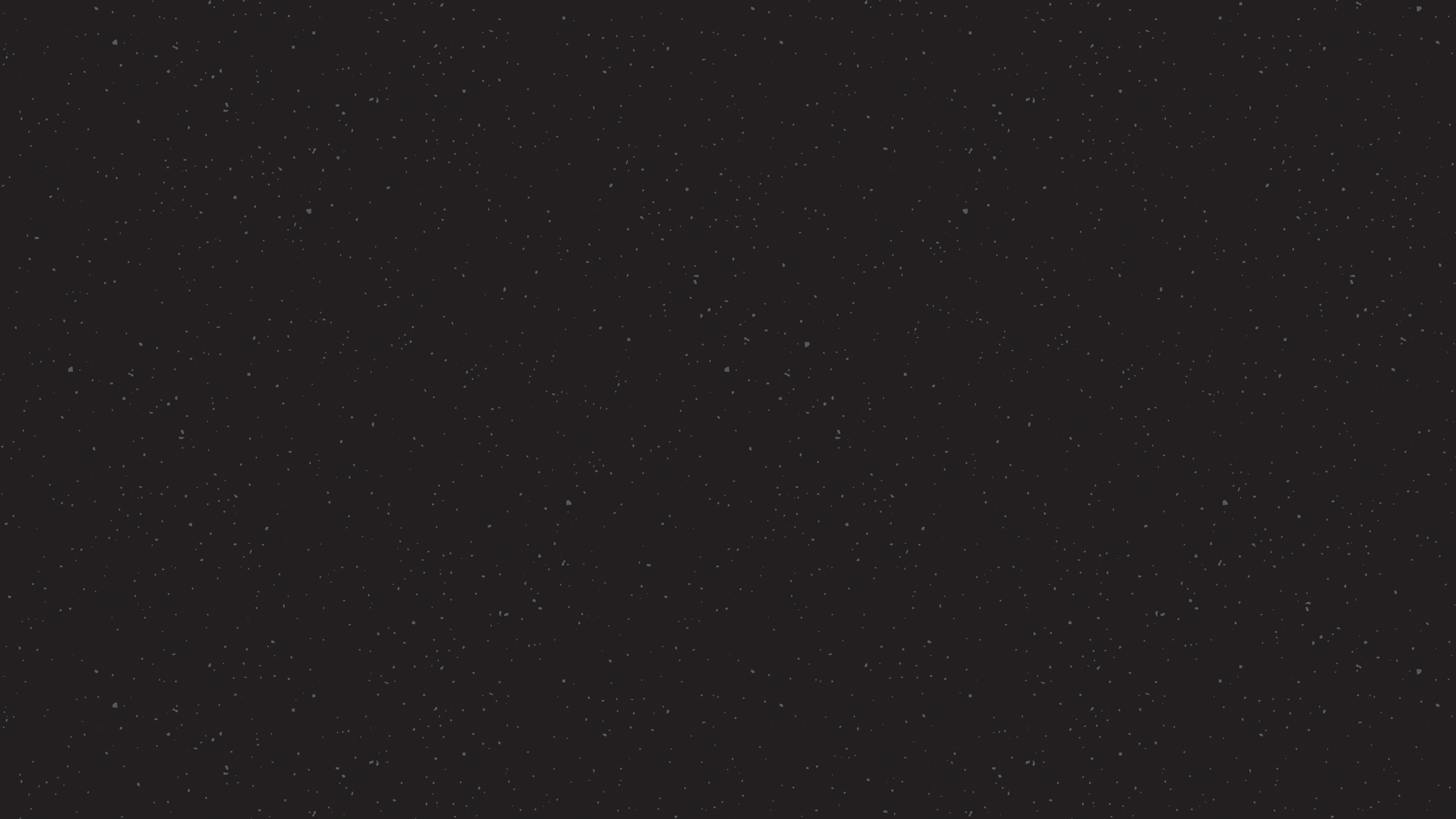 Black background with speckled texture. 