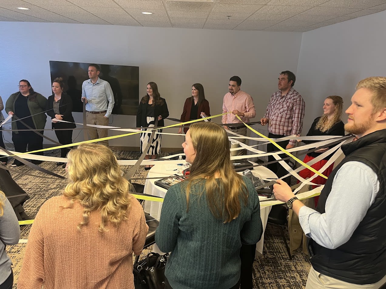 Group of people playing an educational game with ribbon.